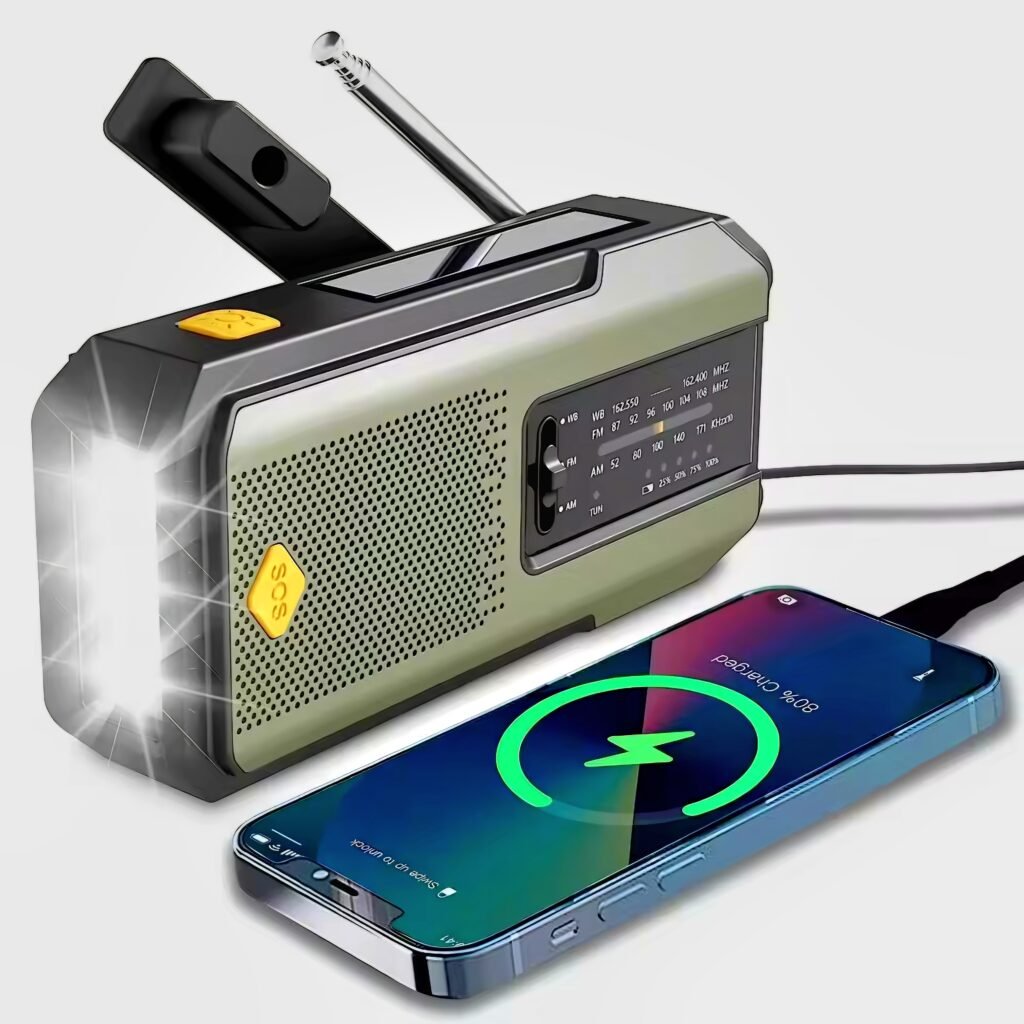 Multifunctional Emergency Hand Crank Solar Radio charging a smartphone with LED flashlight on