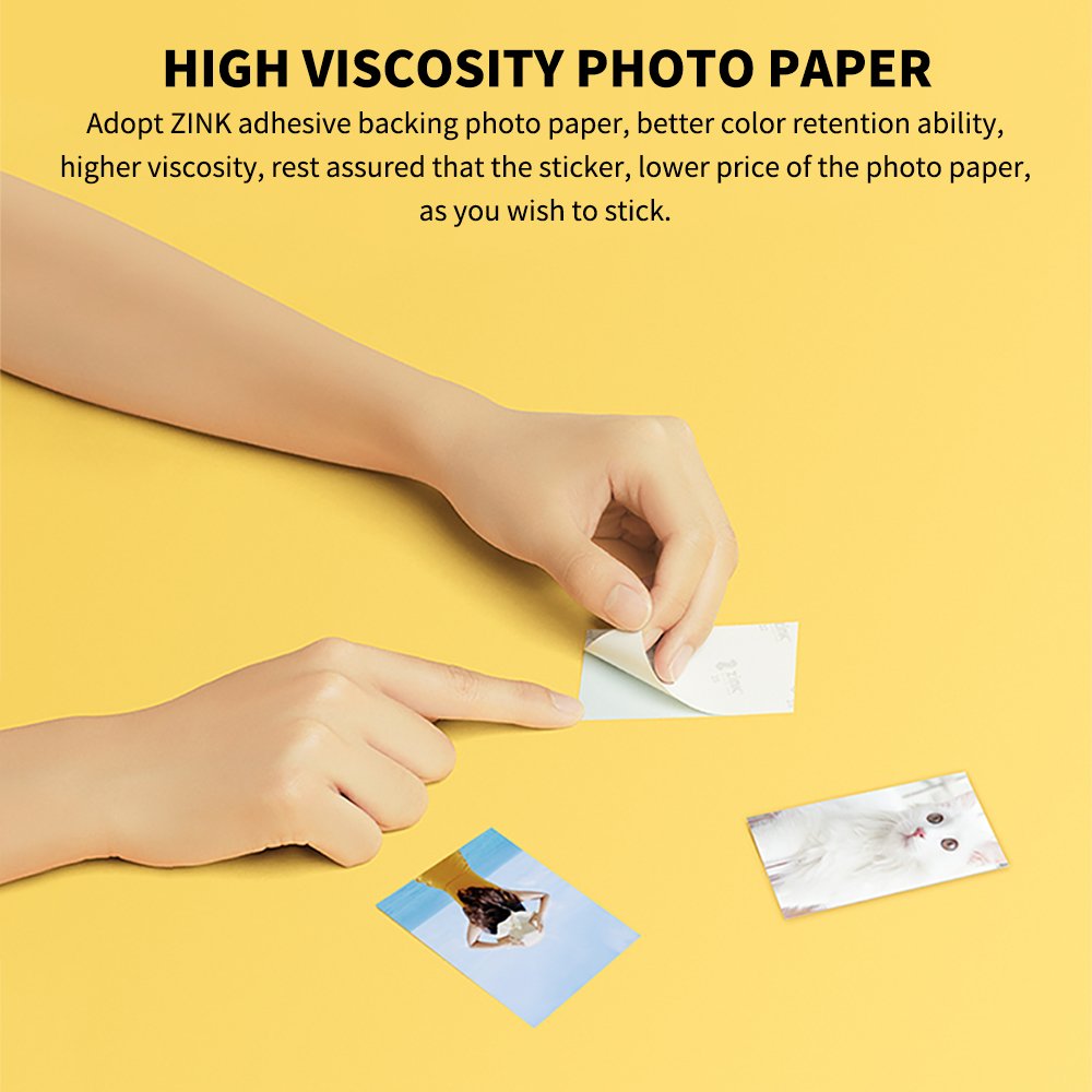 Hands applying adhesive photo paper