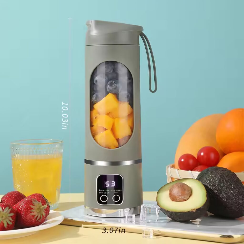 Grey portable smoothie blender filled with yellow fruit chunks standing on a table