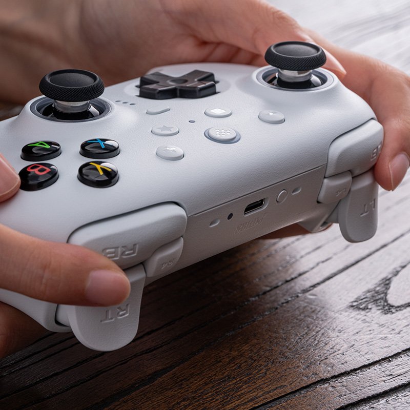 8BitDo Ultimate 2 white wireless controller held in hands