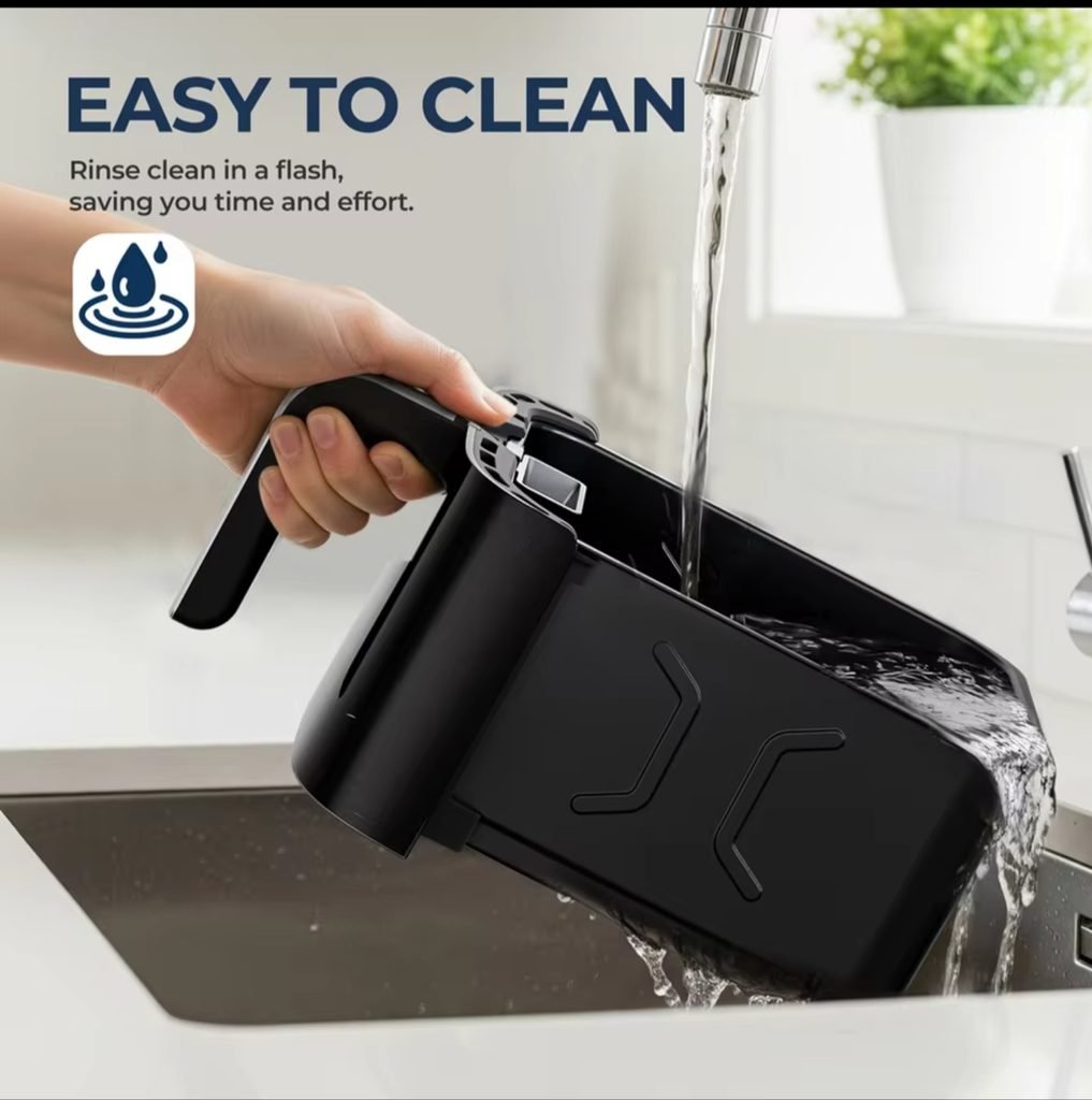 Non toxic air fryer ROUNY basket being rinsed clean under water